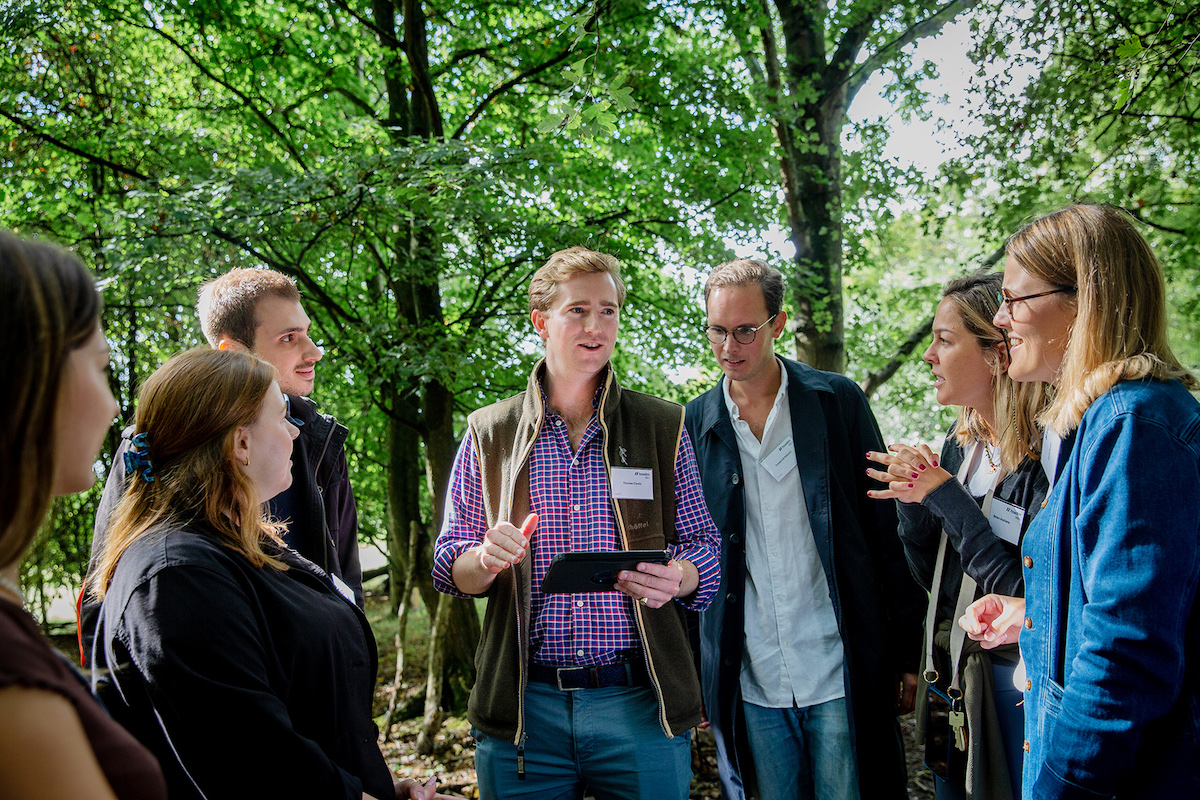 away day corporate photography carmen valino Team talking in forest away day London event photography