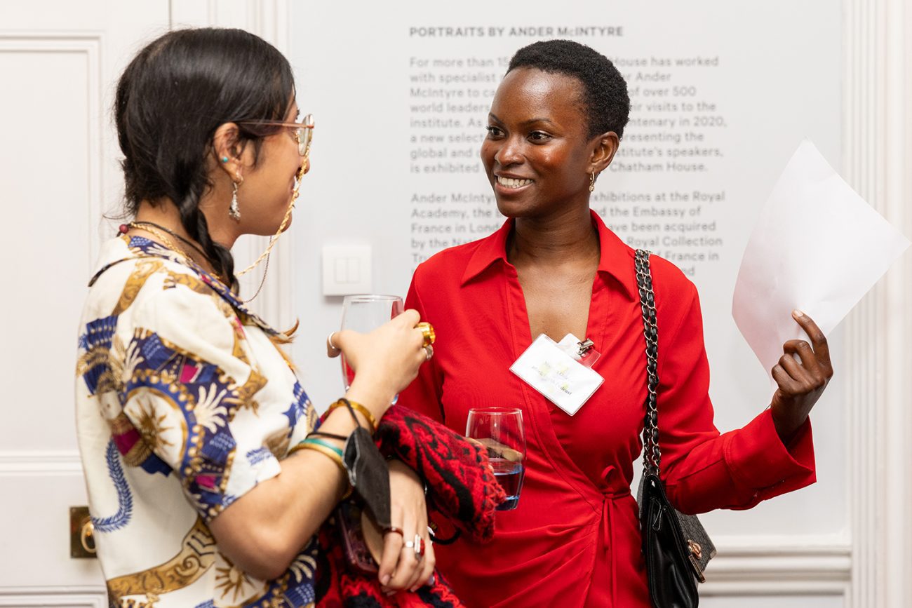 Conference photography two women engaged in conversation during a networking break at Chatham House London