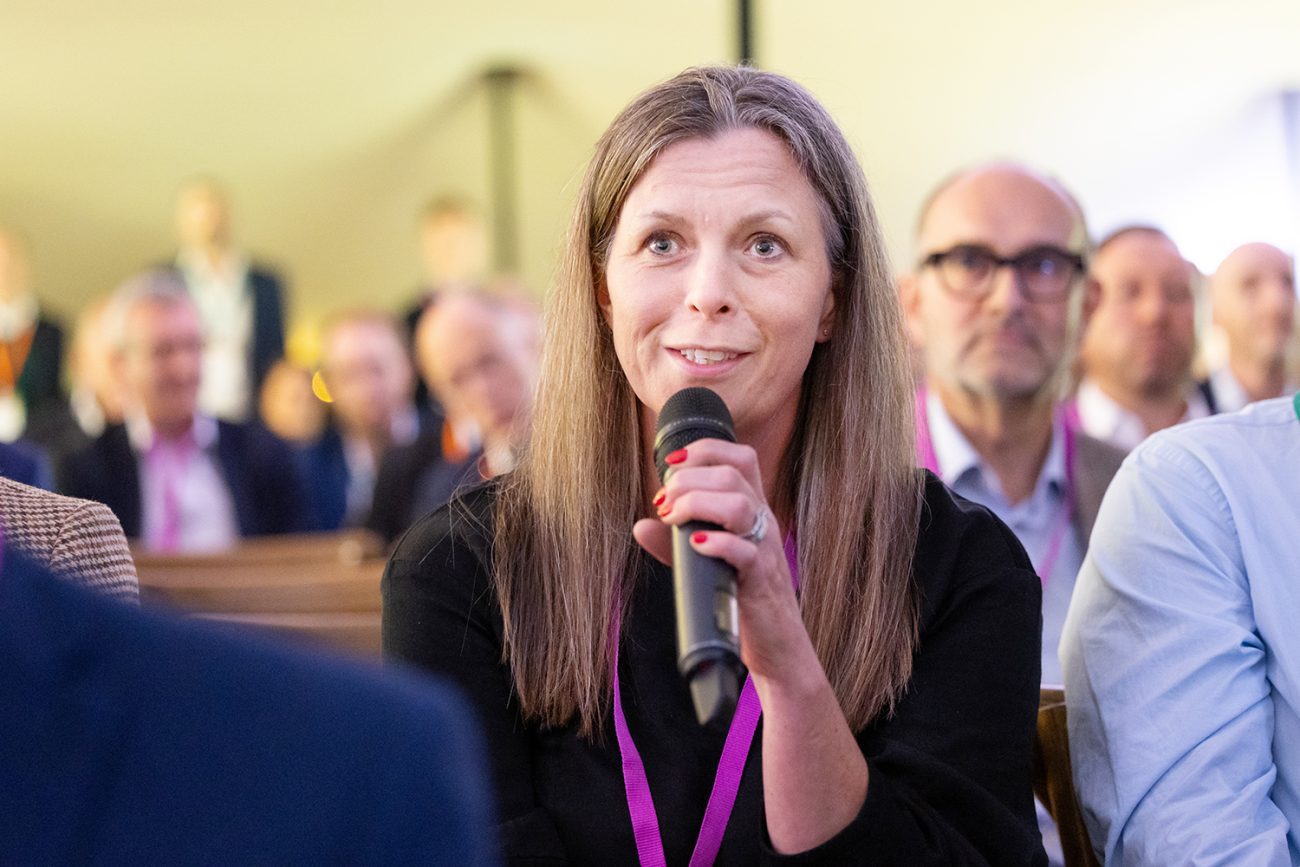 Conference photography at Regents Venues a woman ask a question during a Q&A session taking place at DC Fest Organised by DC Advisors in London UK